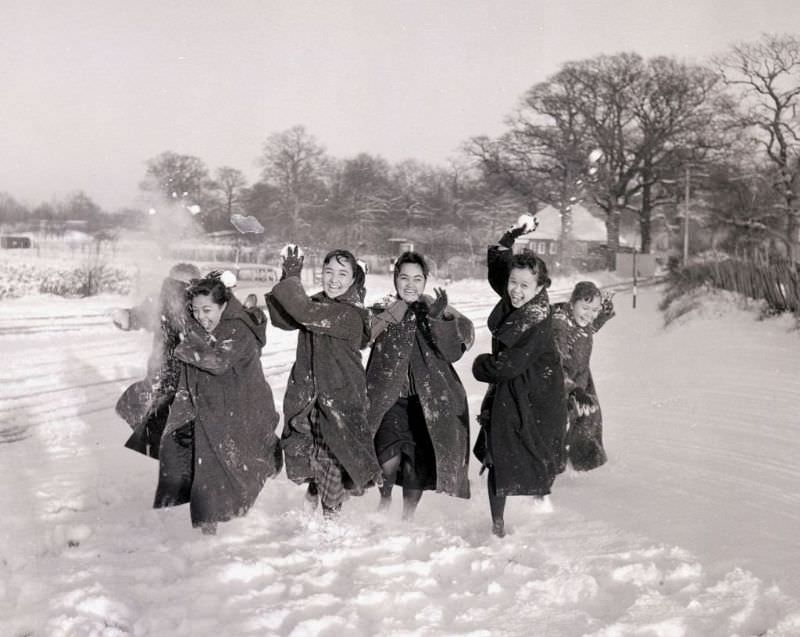 Filipino dancers having fun during a snowball fight, London, 1960.