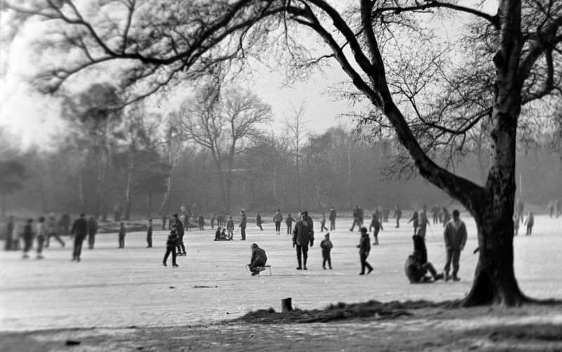 People ice skating on a frozen lake during the winter in 1963.
