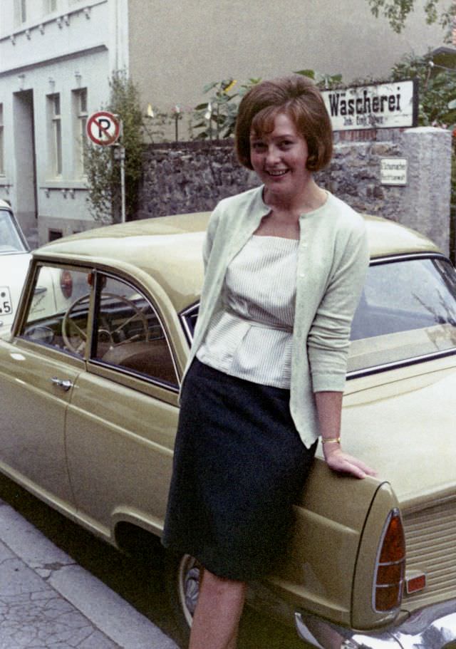 A cheerful young lady posing with a DKW Junior in a narrow old town street, 1963