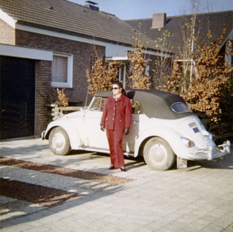 A lady posing with a VW 1200 Cabriolet in front of a middle-class home on a sunny autumn's day. The print is dated "1968" on reverse, the car is registered in the West German city of Münster