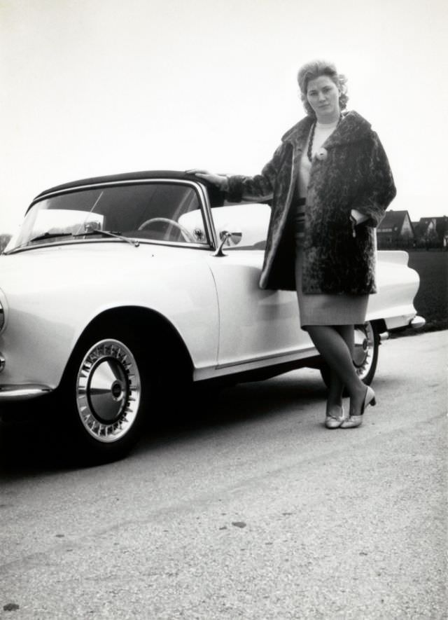 A blonde lady seductively posing with a Auto Union 1000 Sp, 1960s