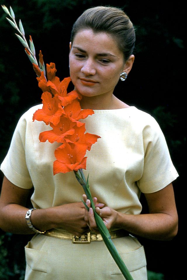Arlene Smith with gladiollas, 1959