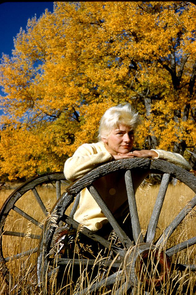 Arlene Smith sitting on wagon wheel, October 1960