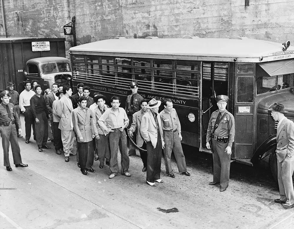 Mexican American “Zoot suiters” lined up outside Los Angeles jail en route to court.