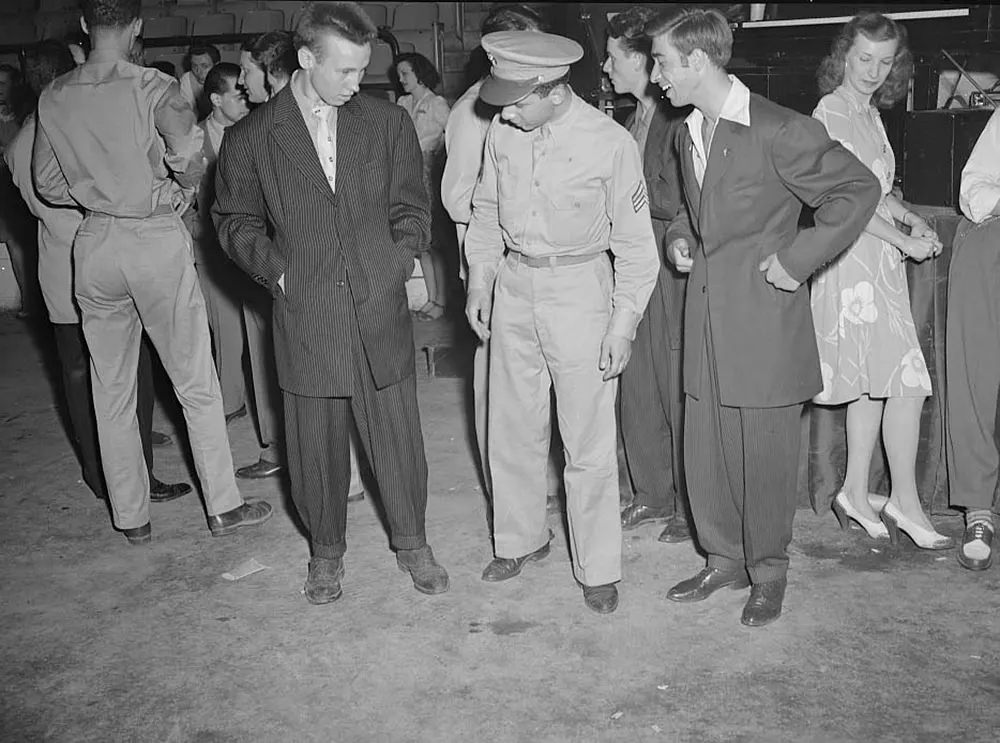 A soldier with two men wearing zoot suits in Washington, D.C., 1942