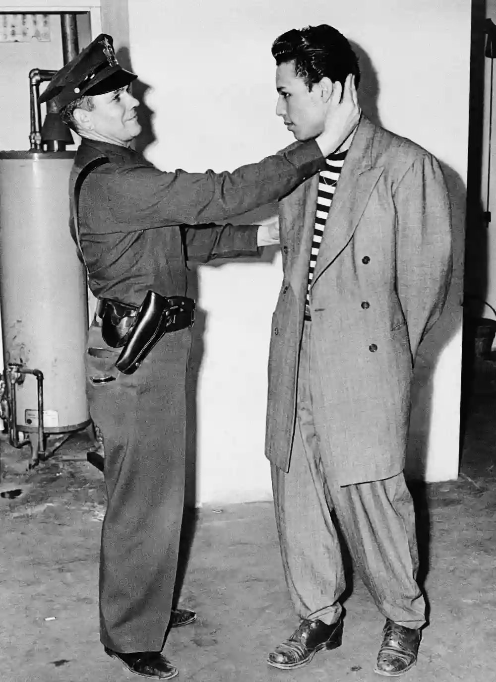 A man in a zoot suit is inspected upon arrest by LAPD on June 7, 1943.