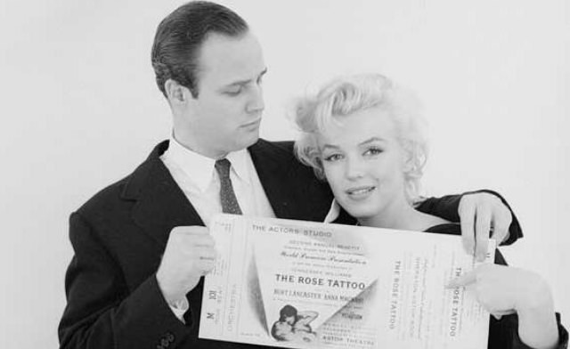 Marlon Brando and Marilyn Monroe holding ticket