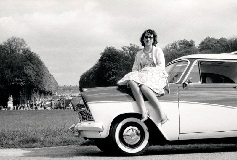 Women pose with cars 1960s
