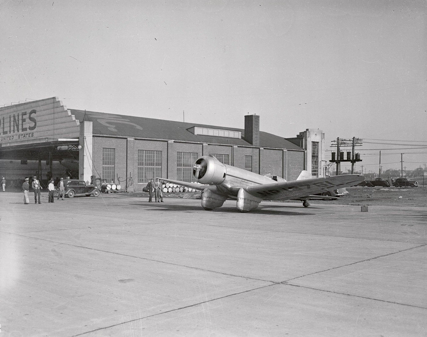 Howard Hughes, motion picture producer, was at the controls when his Mystery Plane had its first real test flight in Los Angeles, 1935