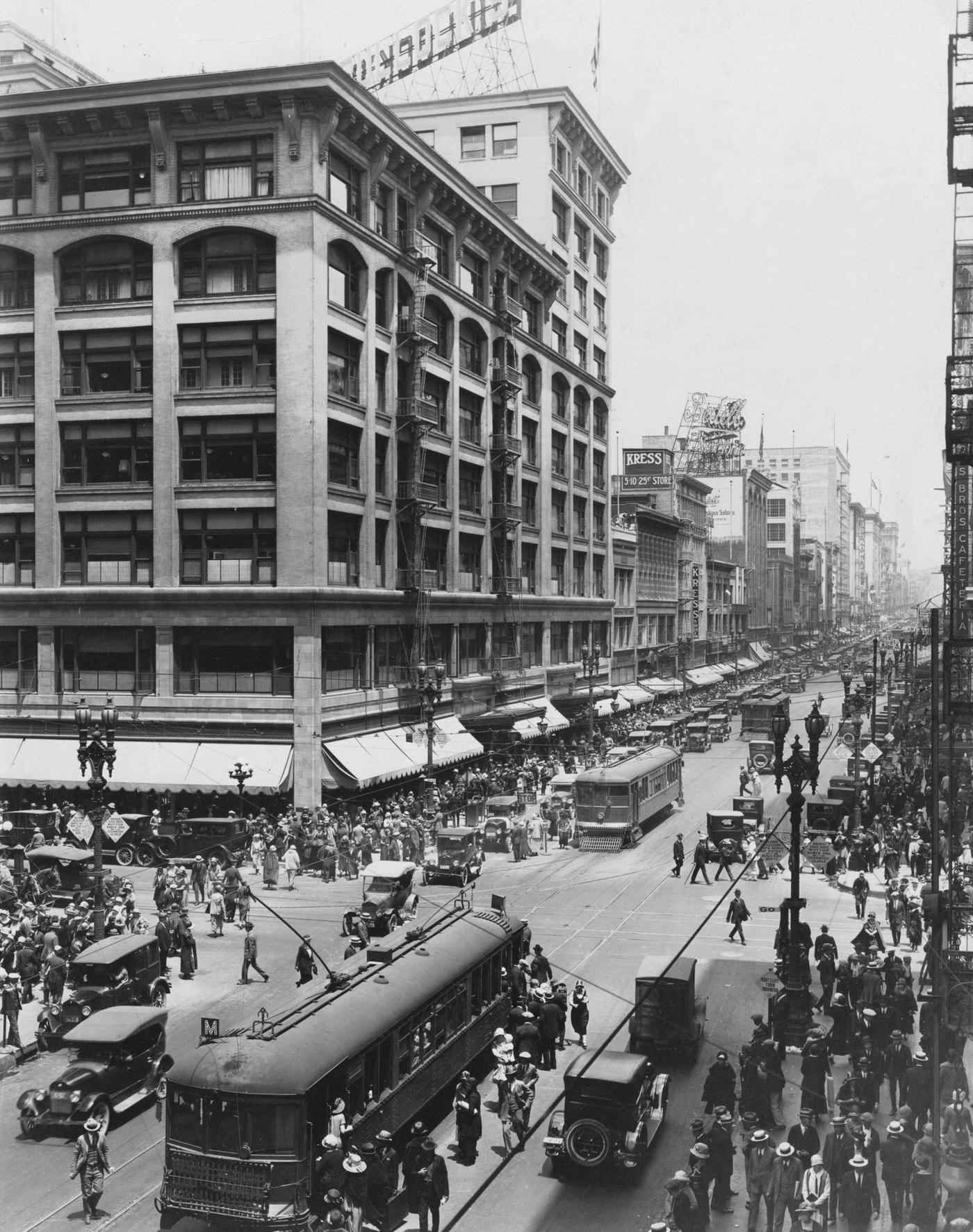 A view, looking north from Seventh Street, of crowds on Broadway, Los Angeles, California, 1930.