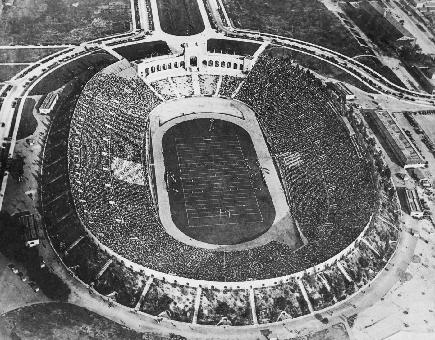 Crowds watching an American football match at the Los Angeles Memorial Coliseum, 1930.