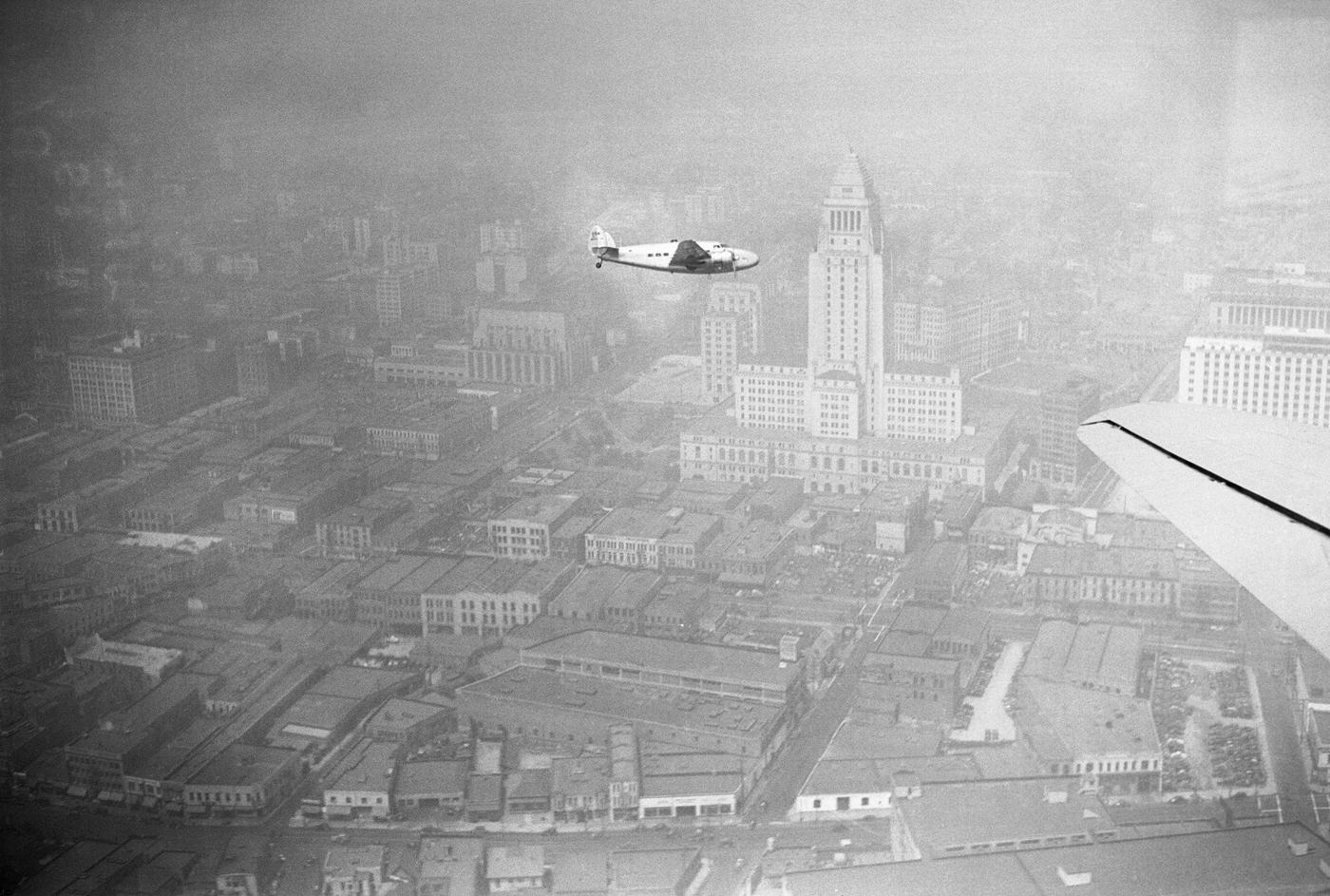 Howard Hughes' world-circling plane pictured from an American Airlines plane as it flew over Los Angeles, 1983