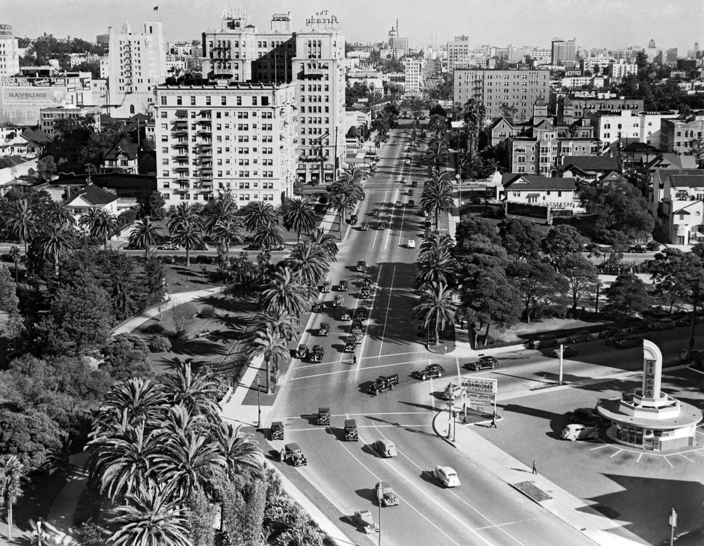 Looking east on Wilshire Blvd at Hoover St with Simon's Drive-In in the lower right and the Arcady Hotel a couple of blocks up on the left, Los Angeles, 1939.
