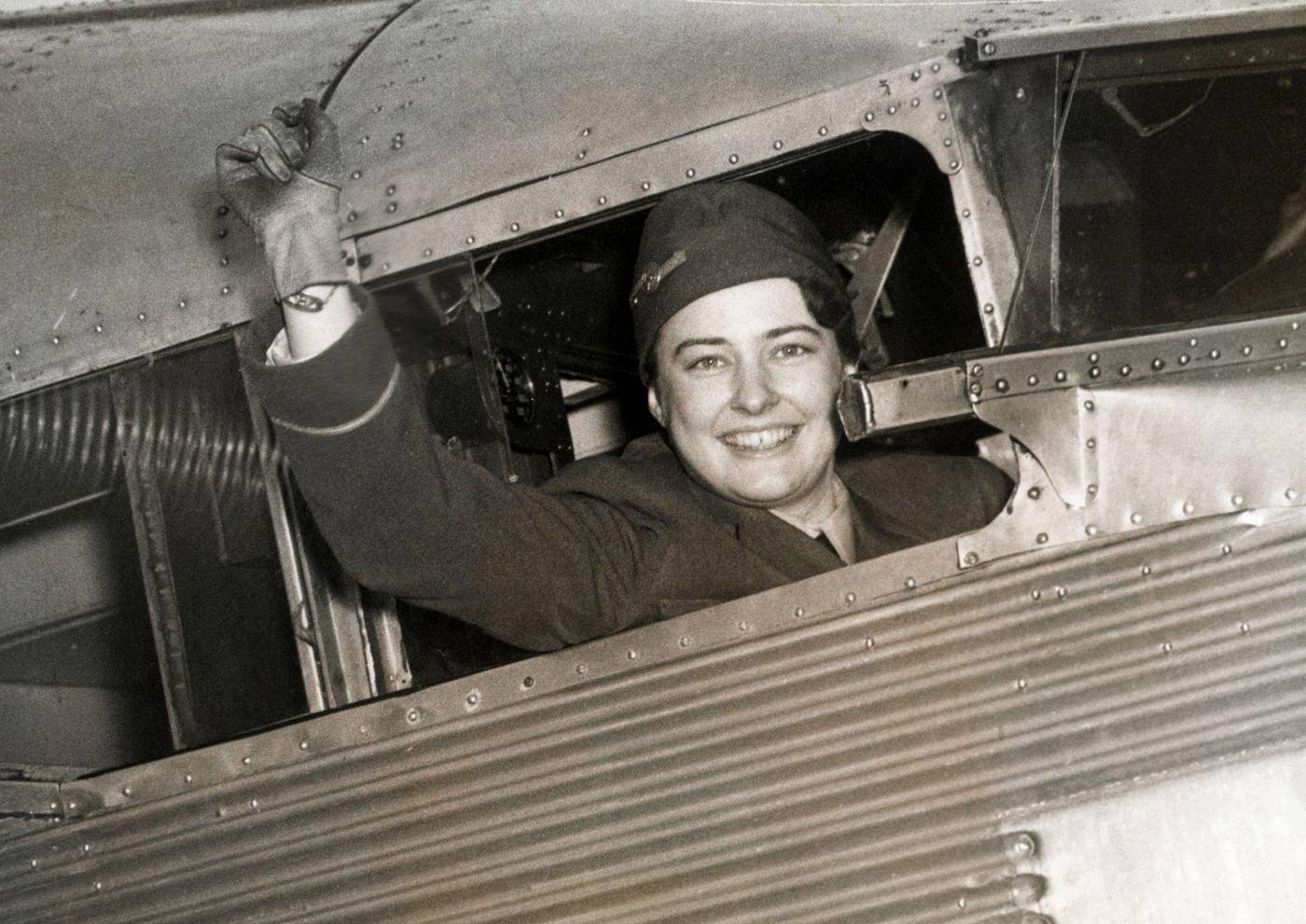 Miss Helen Rickey, first woman to be employed as a pilot of an airline has resigned her position. Photo of Miss Rickey in the pilot's seat of her plane leaving the Washington Airport.