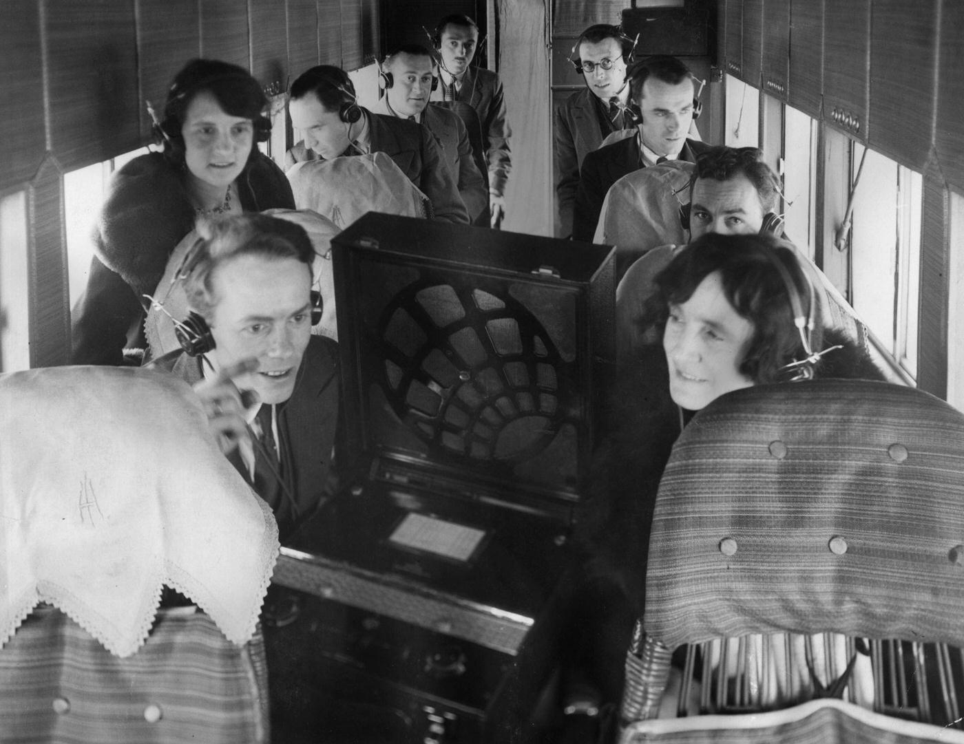 Passengers listening to a radio on board an airplane.
