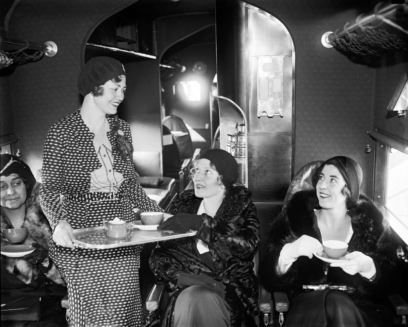 An Eastern Air Transport flight attendant serves tea to passengers, 1931