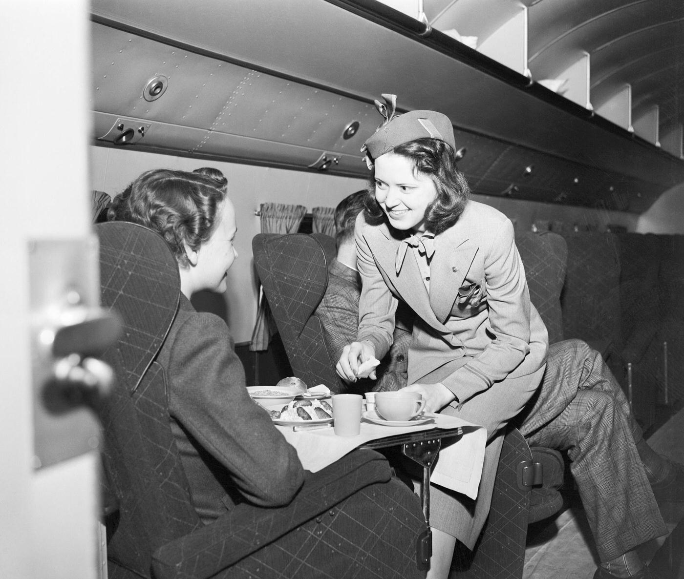 Flight Attendant Serving Passenger a Meal