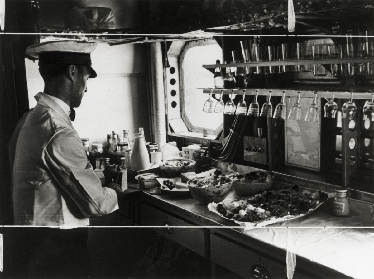 Preparing lunch on the Imperial Airways airplane ‘Scylla’, 19 November 1936.