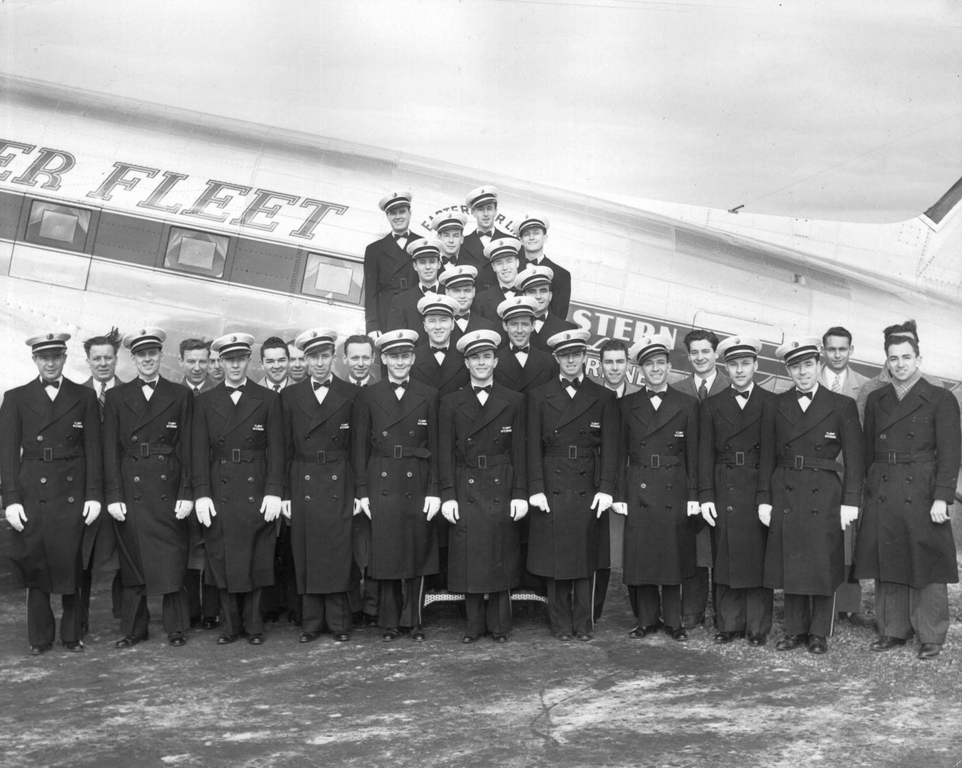 A group portrait shows uniformed flight stewards posing in front of the Eastern Airlines 'Silversleeper' airplane, a passenger and mail delivery plane.