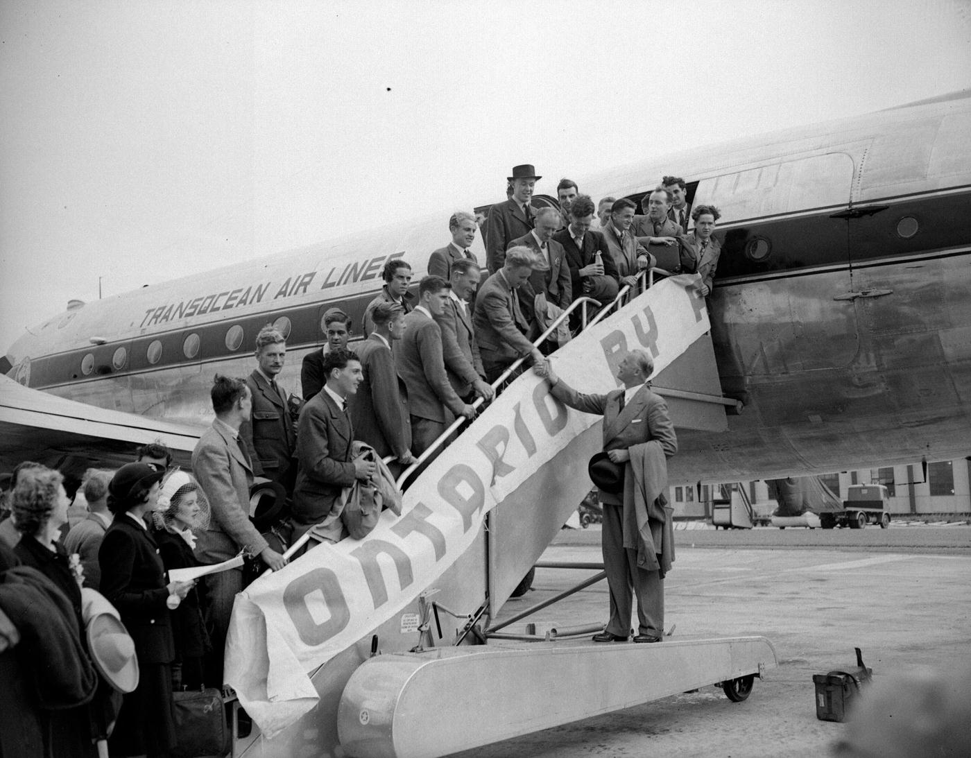 In 1947, J S Armstrong of the Canadian consulate is saying goodbye to a group of emigrants leaving for Ontario.