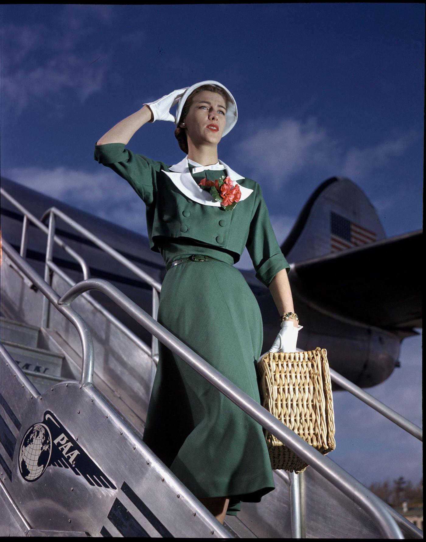 In 1947, a model poses as a passenger walking off the Pan American Clipper "Challenge" Lockheed 1049 airliner.