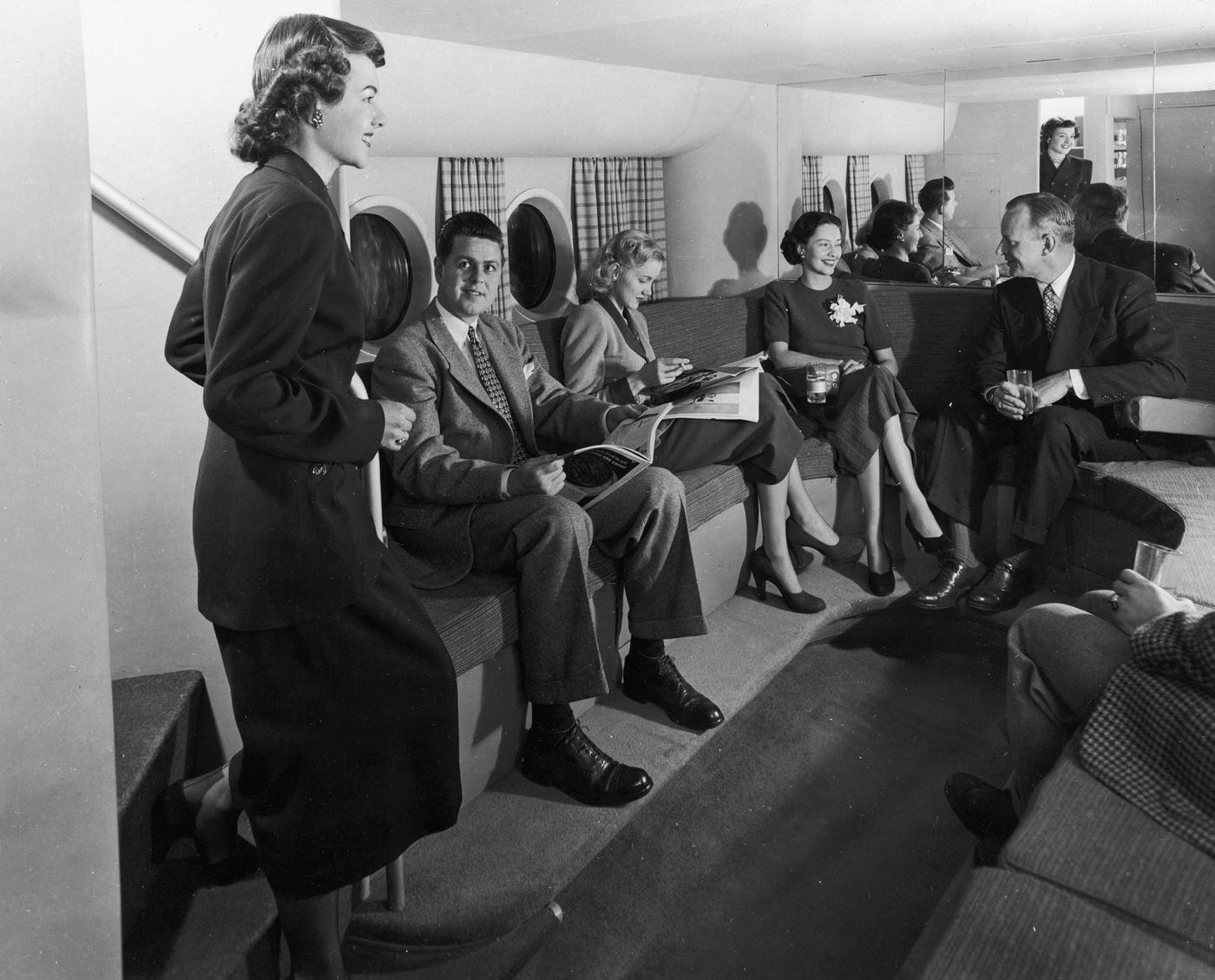 Passengers are relaxing in the luxury lounge of a Boeing airplane in 1945.