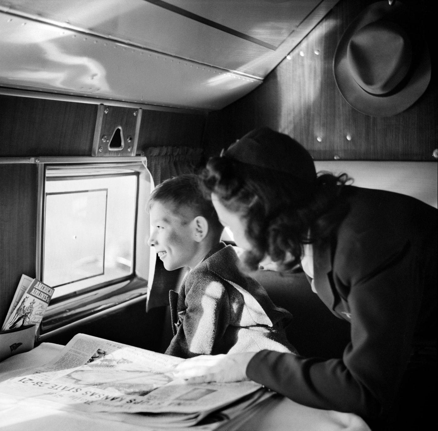 In December 1941, a child passenger and a female flight attendant are pictured during an American Airlines flight from Washington to Los Angeles.