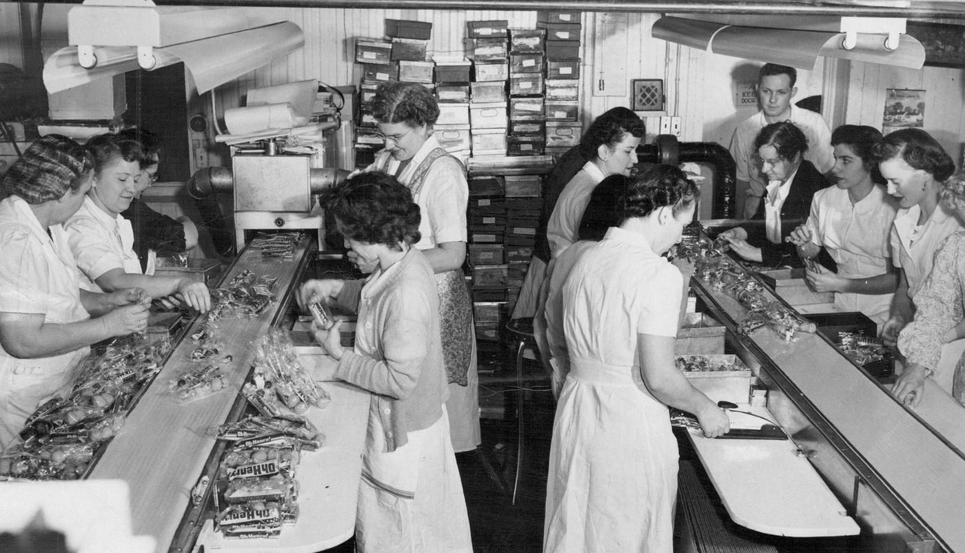 Employes are shown assembling and packing 20,000 bags in the candy shop at Baur's in scene 2050.