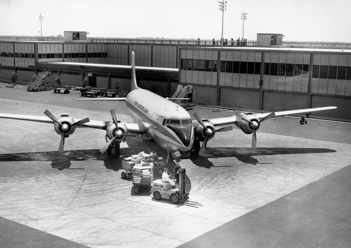 Luggage being unloaded from airplane, 1950s