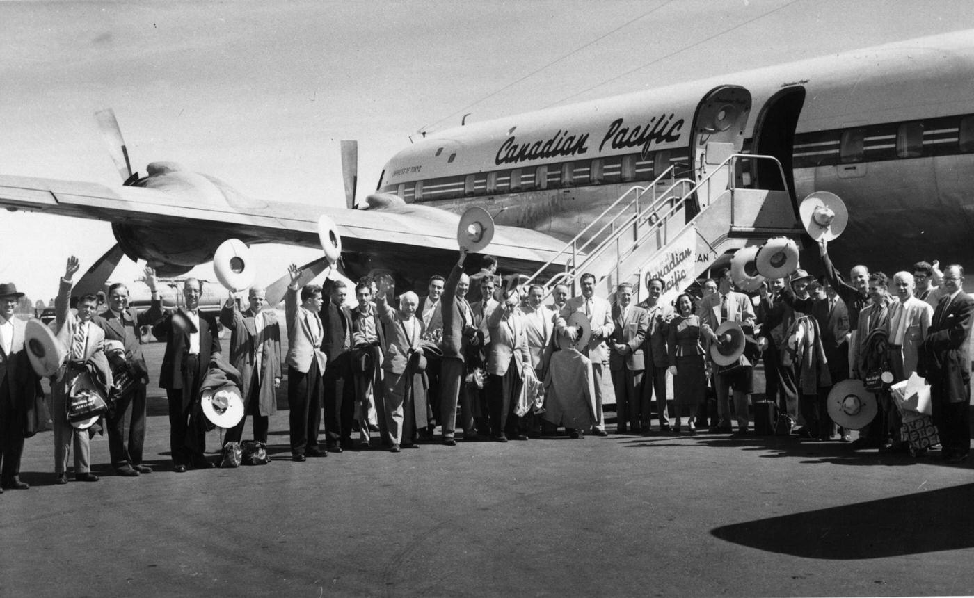 Tourists raise Mexican sombreros before boarding a Canadian Pacific jet in Mexico in 1950.