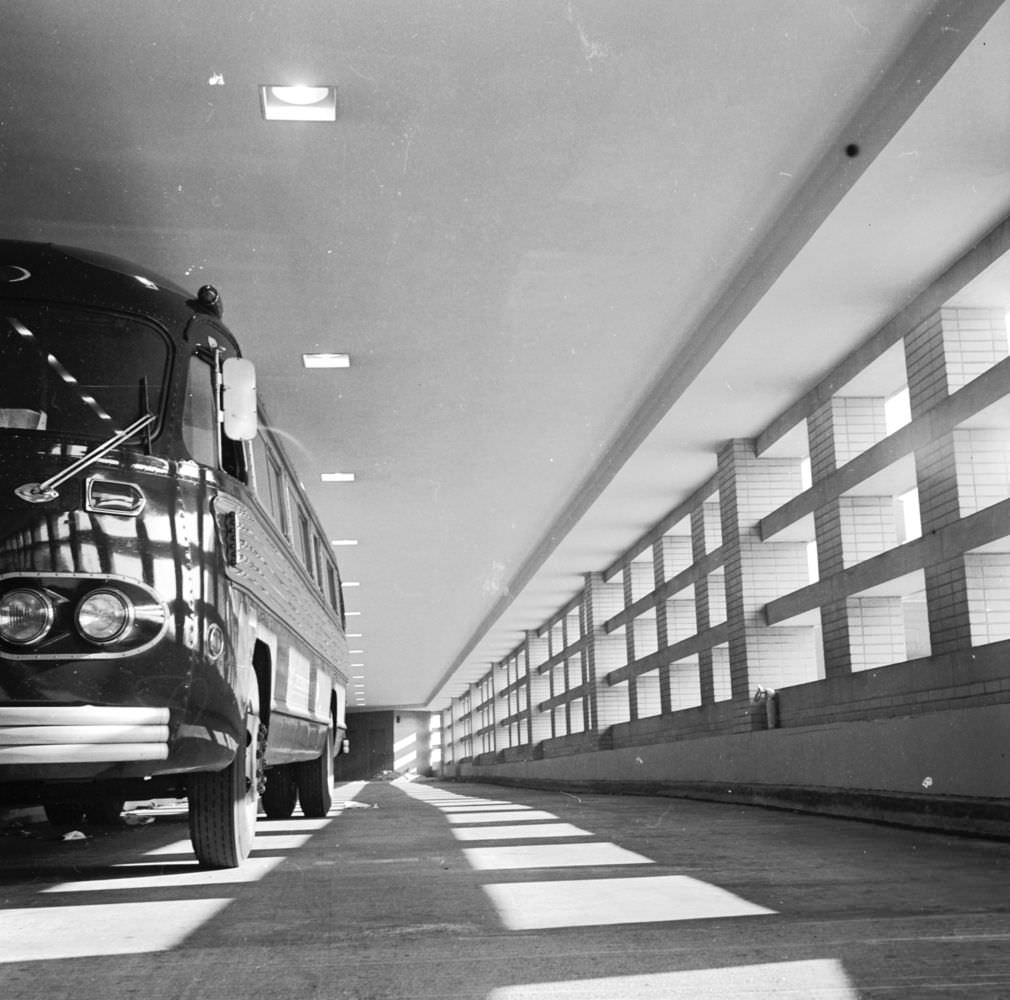 A bus in bus docks at New York’s East Side Airlines Terminal. The docks are open on one side to permit exhaust fumes to escape, 1950s