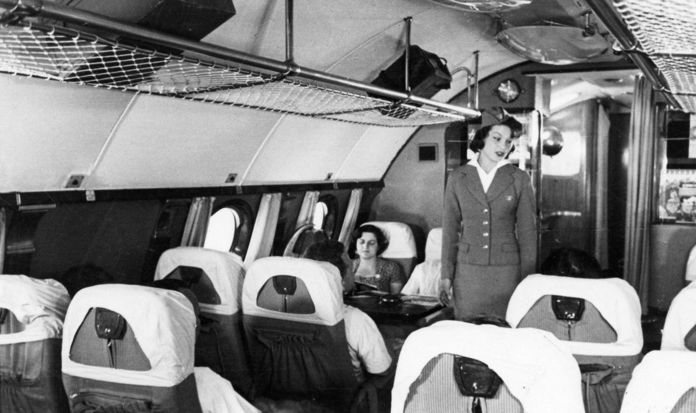 Passengers and a stewardess are pictured aboard a TU114 airliner, which was the world's largest at the time, in 1959.
