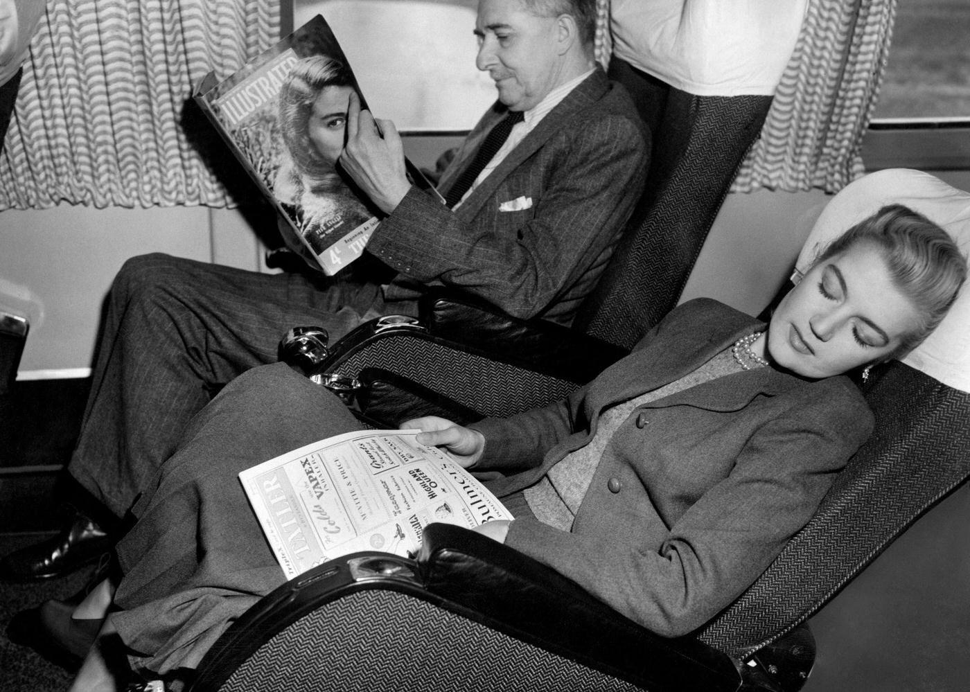 A couple is seen aboard a British Overseas Airways Corporation plane in 1958.