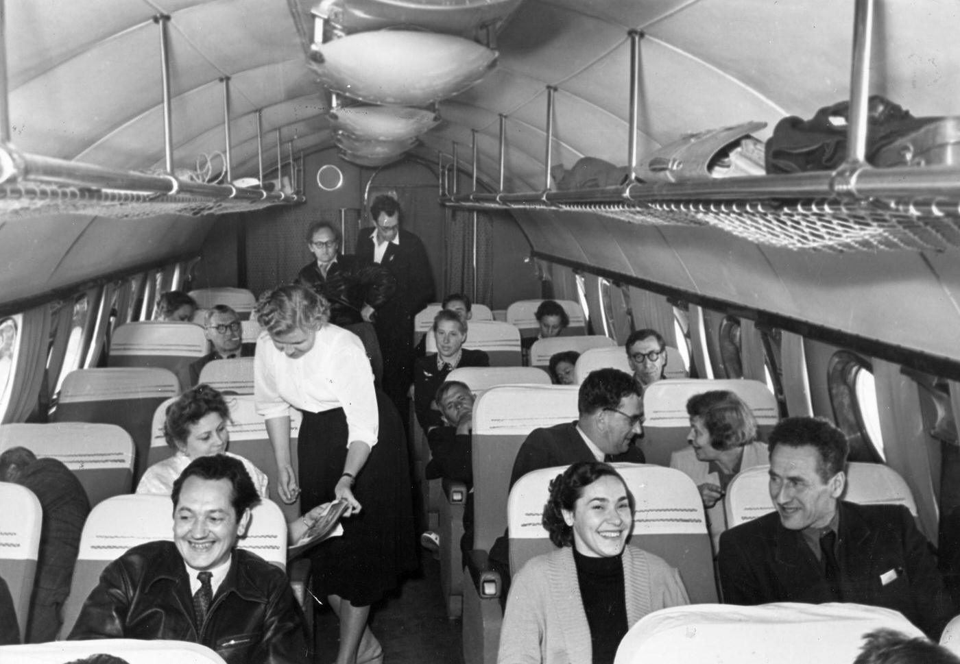Passengers are depicted on a transSiberian flight on board a TU104 airliner in July 1956.