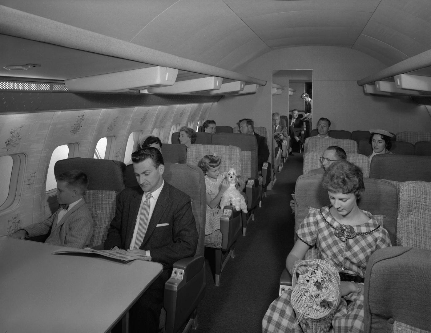 Passengers are depicted on a Transocean Air Lines Boeing 377 Stratocruiser in the mid1950s.