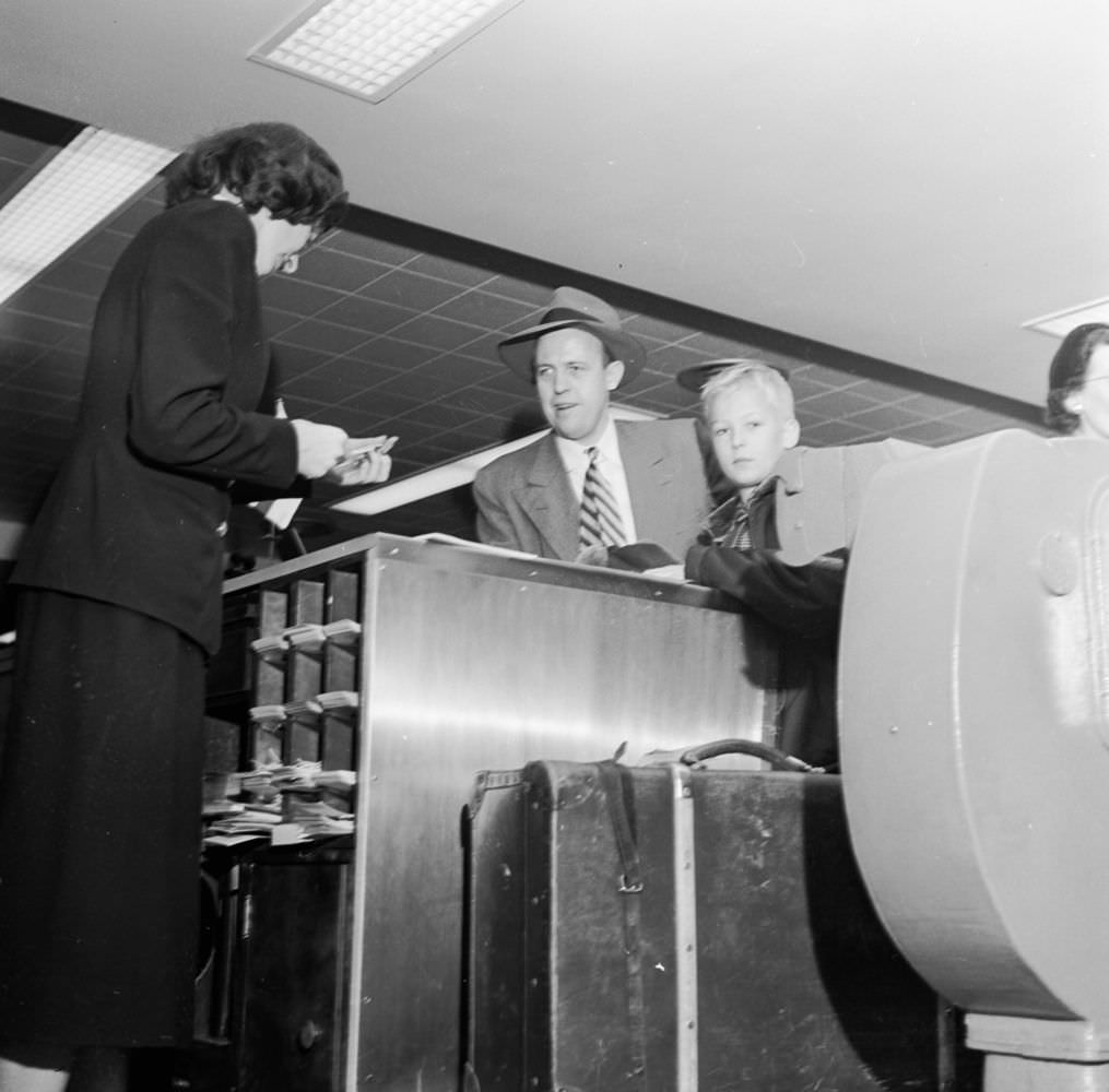 Passengers checking in their baggage at New York’s East Side Airlines Terminal, 1950s