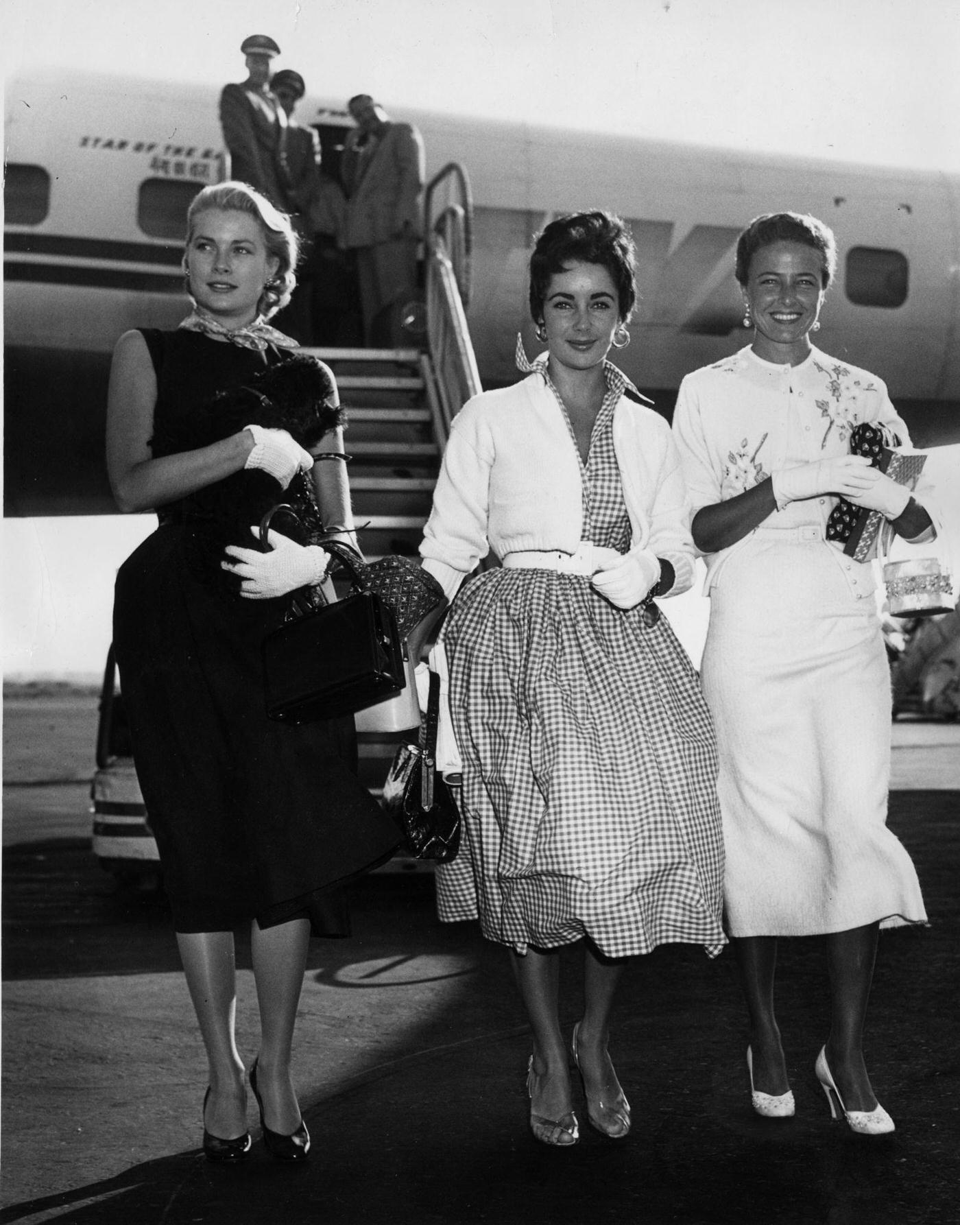 Britishborn American actress Liz Taylor arrives at New York International Airport with fellow actresses Grace Kelly and Lorraine Day in 1955.