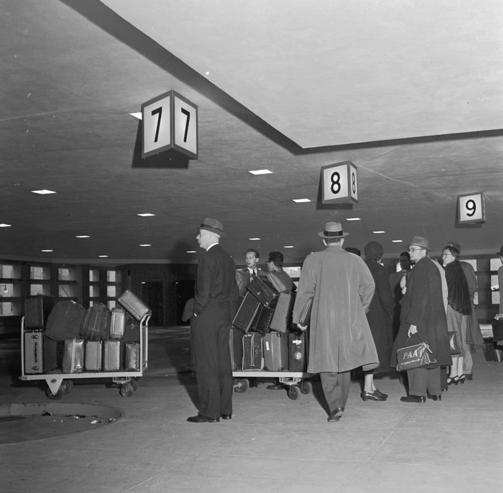 Passengers checking in their baggage at New York’s East Side Airlines Terminal, 1950s