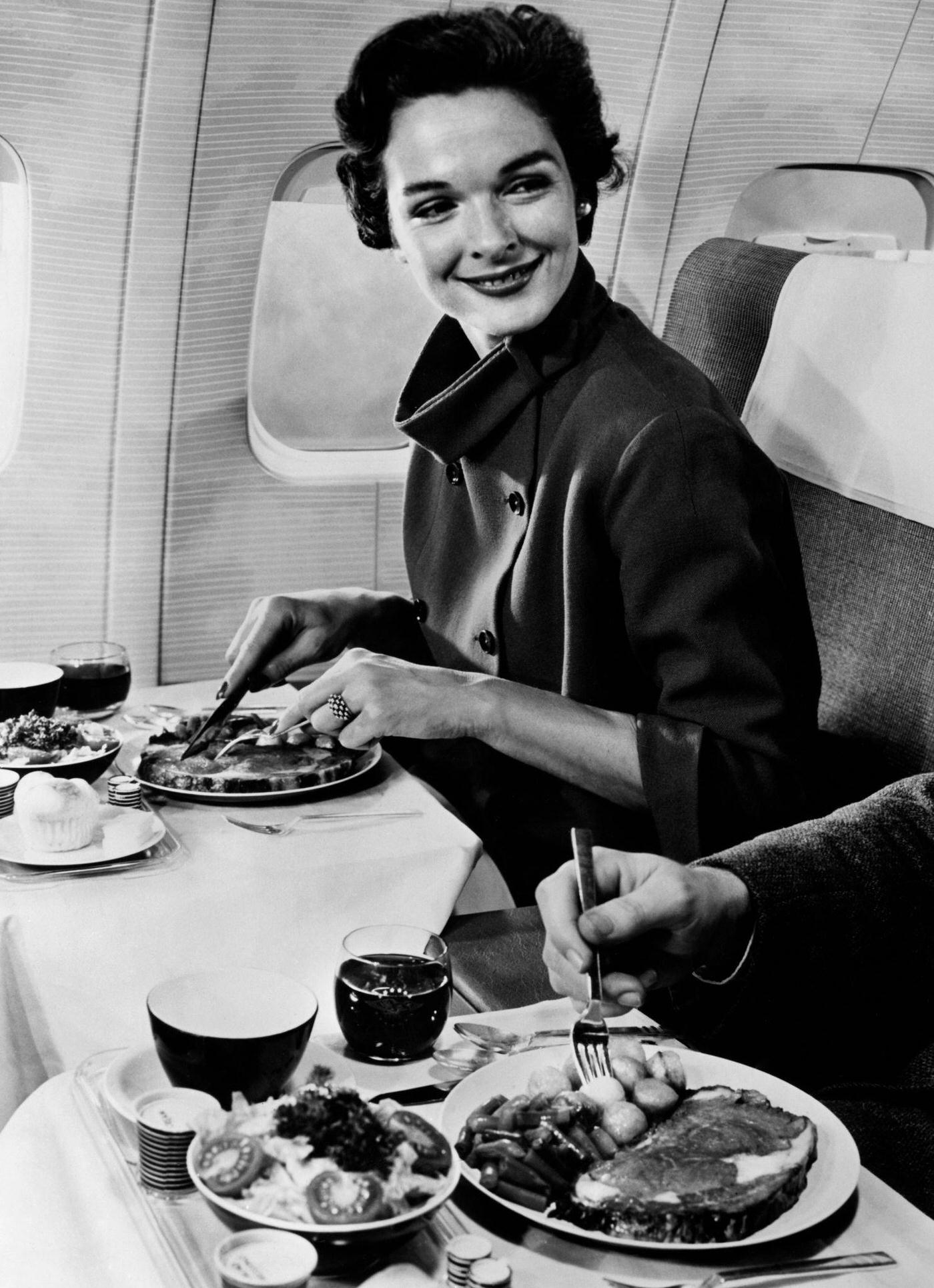A woman on a plane in 1960.