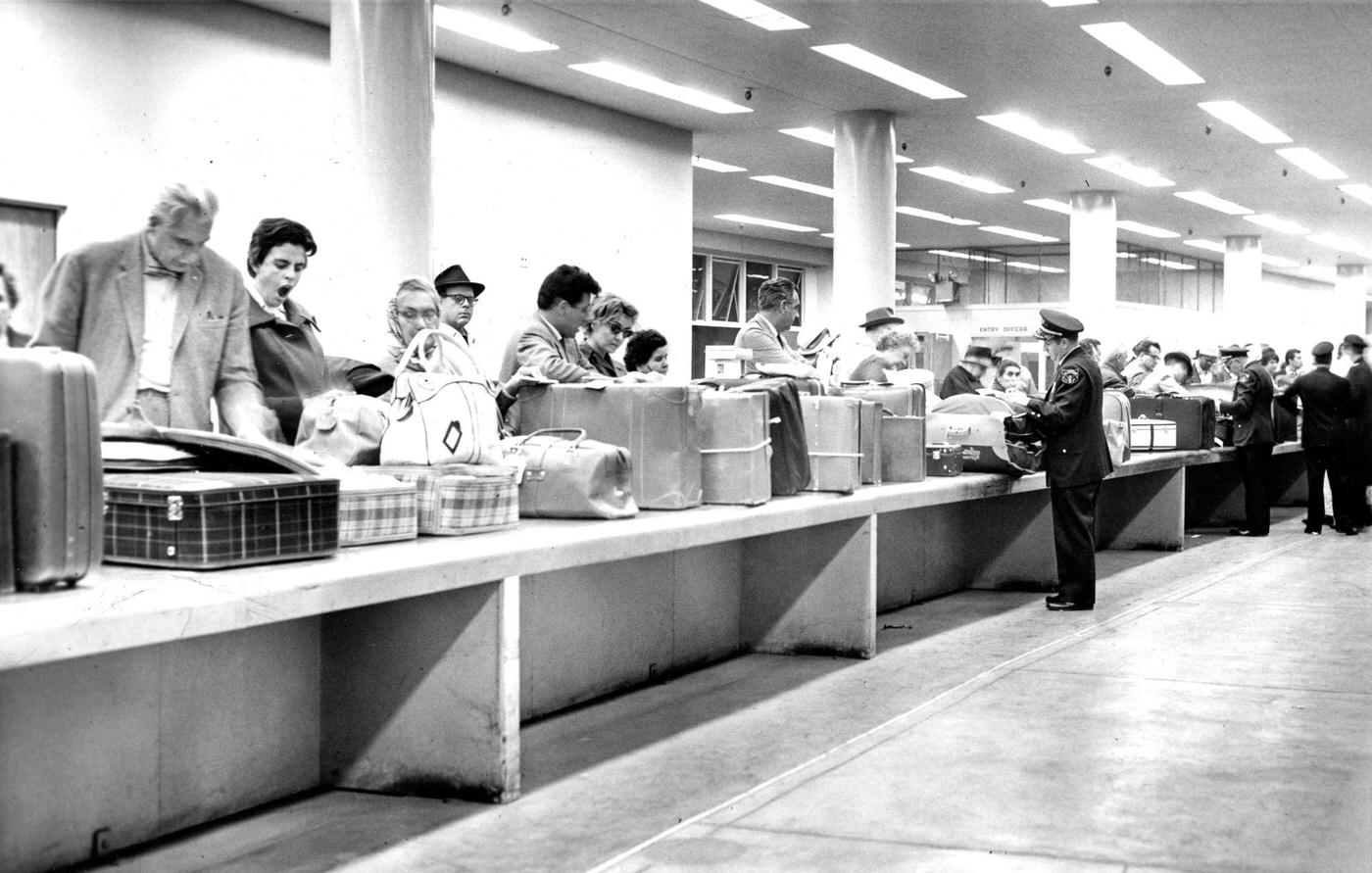 Overseas airline passengers waiting to be cleared by the U.S. Customs Department at Logan Airport in Boston in May 1961.