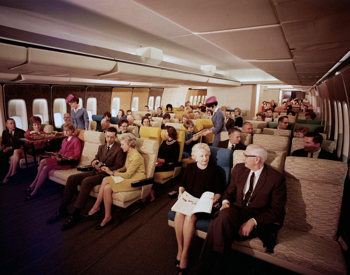 Passengers sitting in one of the living rooms of a tourist class Boeing 747 during the 28th Paris Air Show at Le Bourget in 1969.