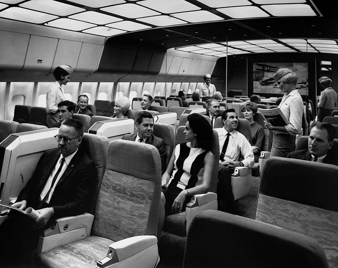 Passengers sitting and relaxing in the mock-up cabin of a Lockheed L-1011 TriStar in Burbank, California, in 1967.