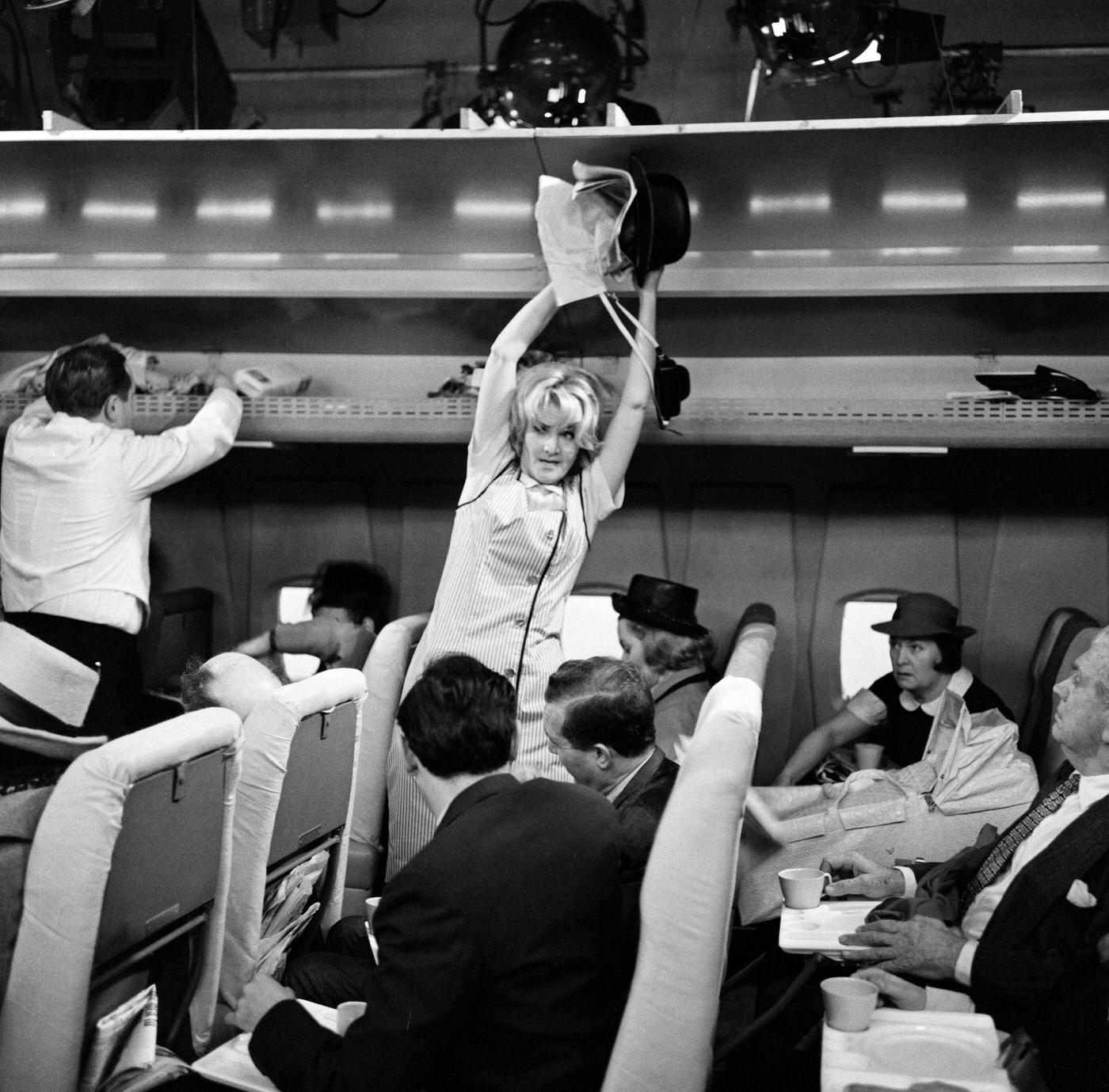 Sheila Hancock playing the role of an air hostess in scenes being shot for the comedy series "The Bed-Sit Girl" at BBC Studios on February 21, 1965.