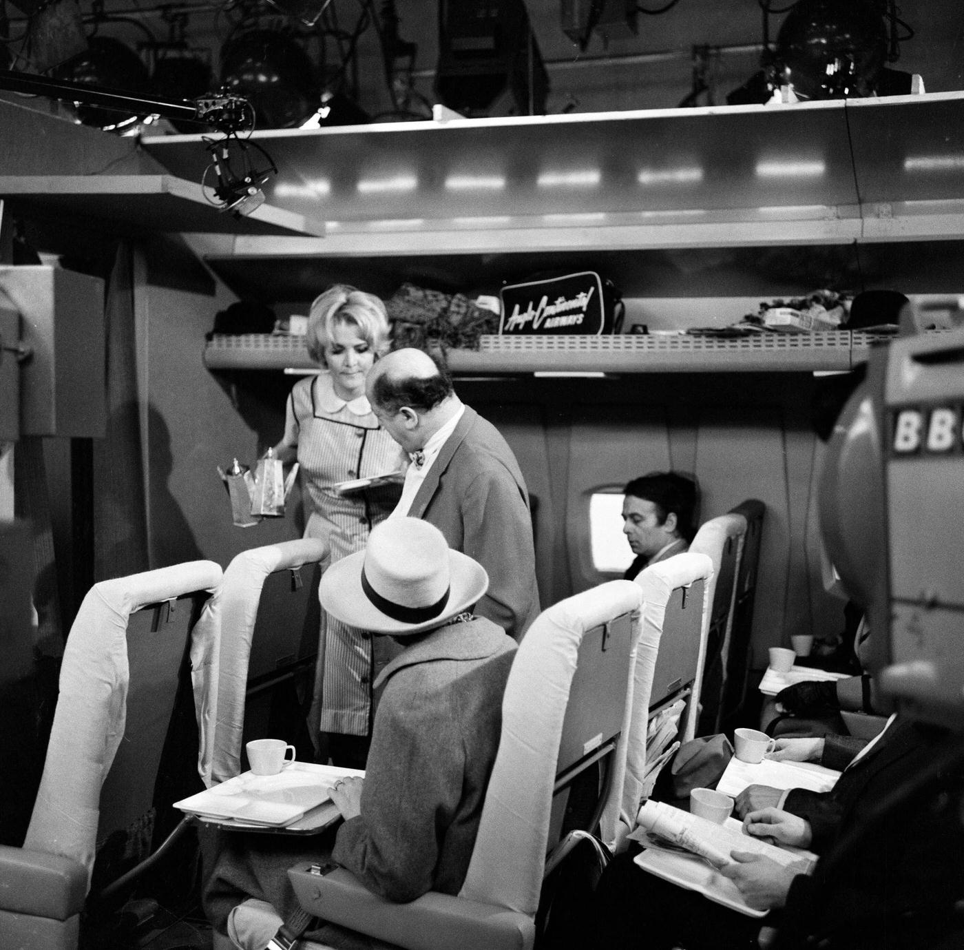 Sheila Hancock playing the role of an air hostess in scenes being shot for the comedy series "The Bed-Sit Girl" at BBC Studios on February 21, 1965.