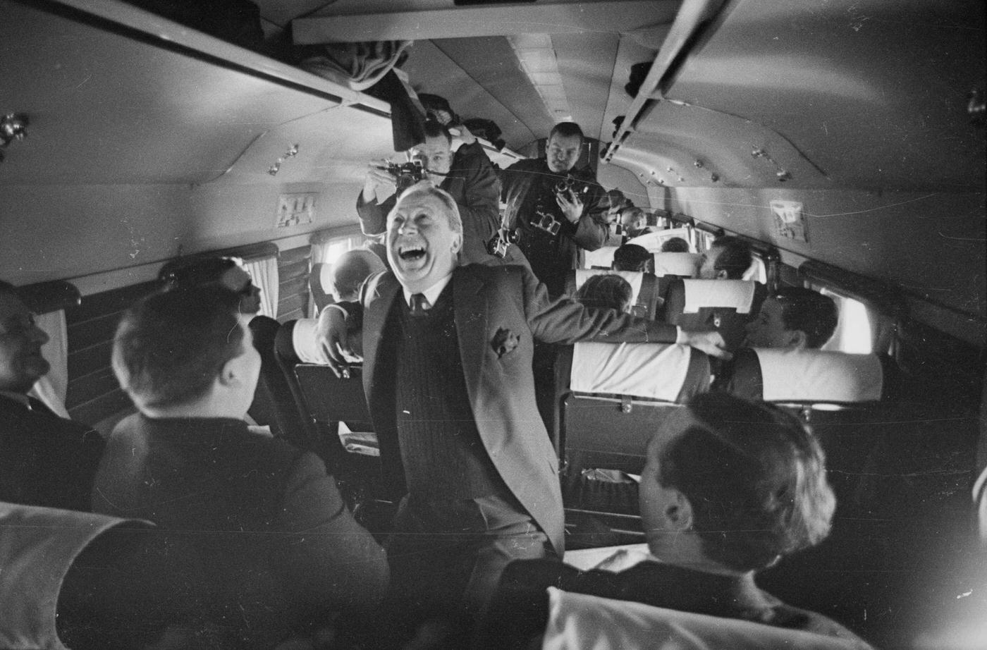Edward Heath, Conservative Party leader, joining in the fun on board an aircraft during his 1966 electioneering campaign on March 23, 1966.