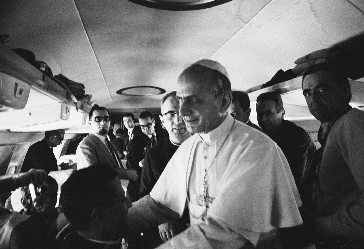Pope Paul VI blessing fellow travellers on a flight to India on December 4, 1964.