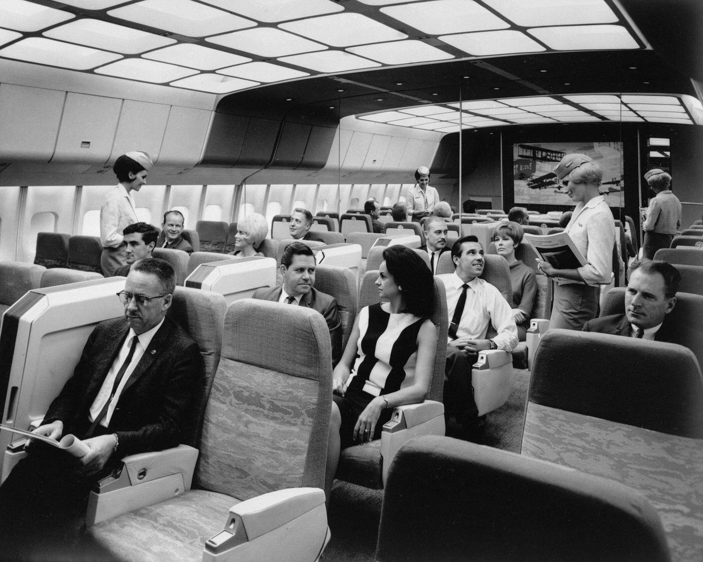 Passengers aboard a spacious Lockheed L-1011 TriStar jetliner mock-up, which provides each passenger with seven square feet of space, almost 17% more than the largest transport flying at the time, in Los Angeles, California in the 1960s.
