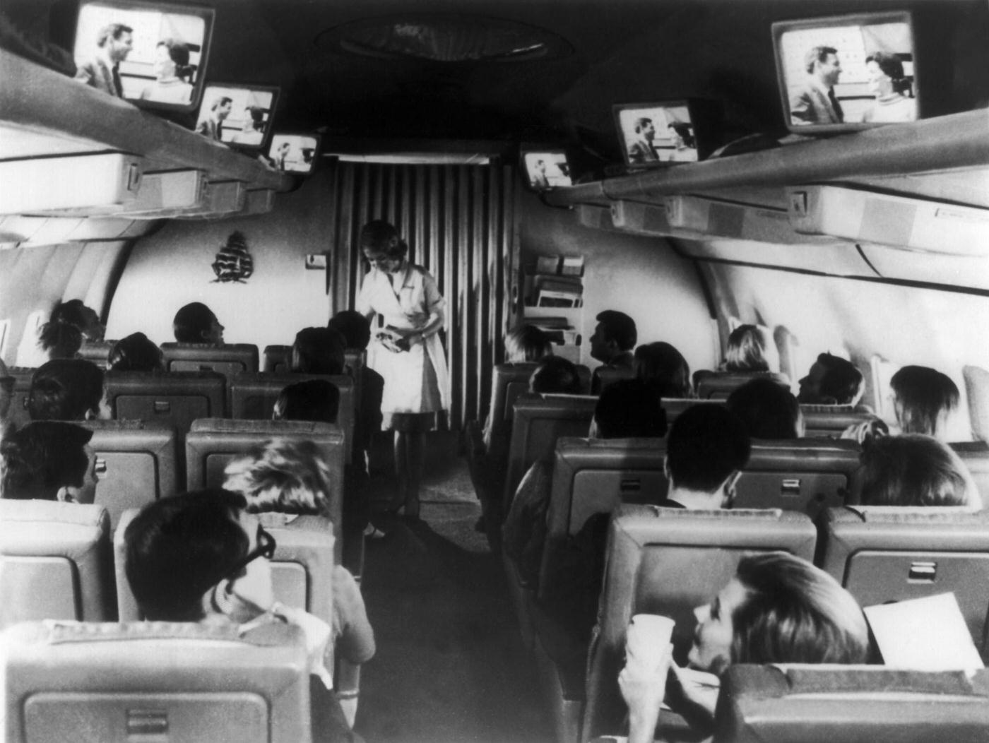 Passengers on a Pan American airplane watching television for the first time. Date unspecified.