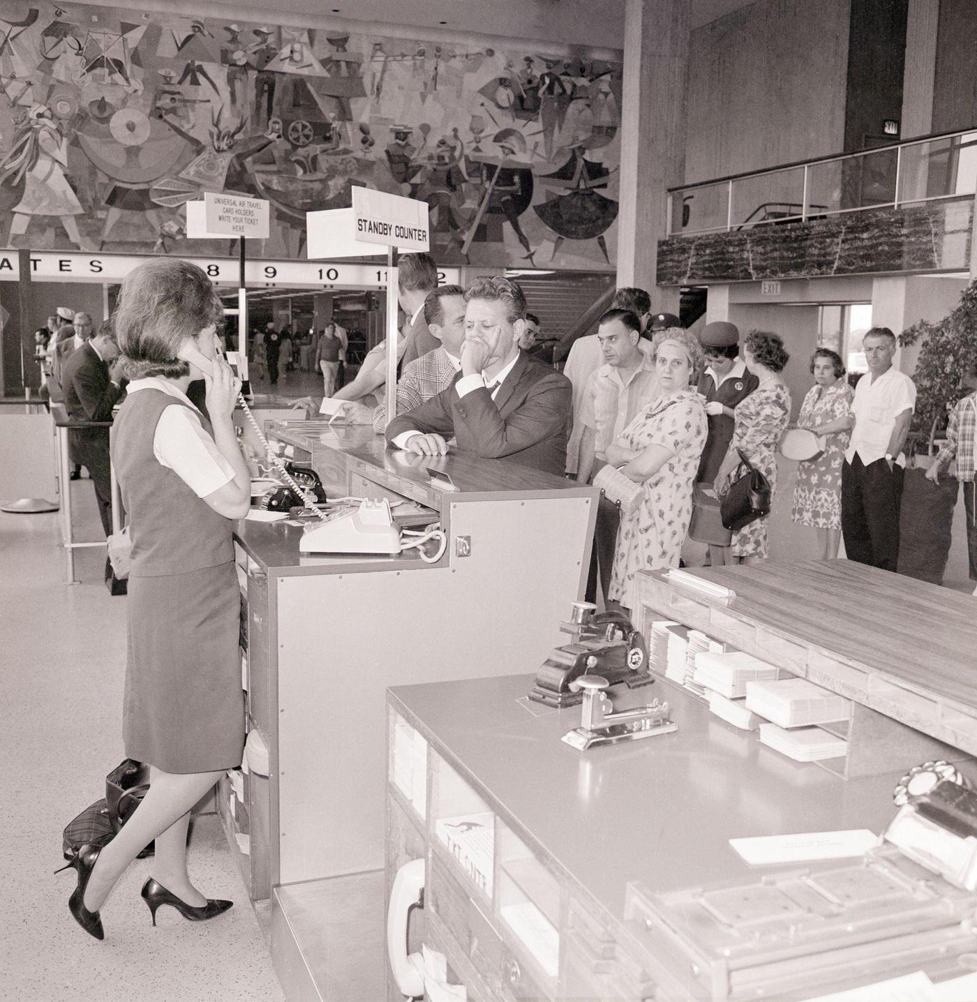 Passengers waiting in line at American Airlines counter at John F. Kennedy International Airport during a machinists' strike. July 8, 1966.