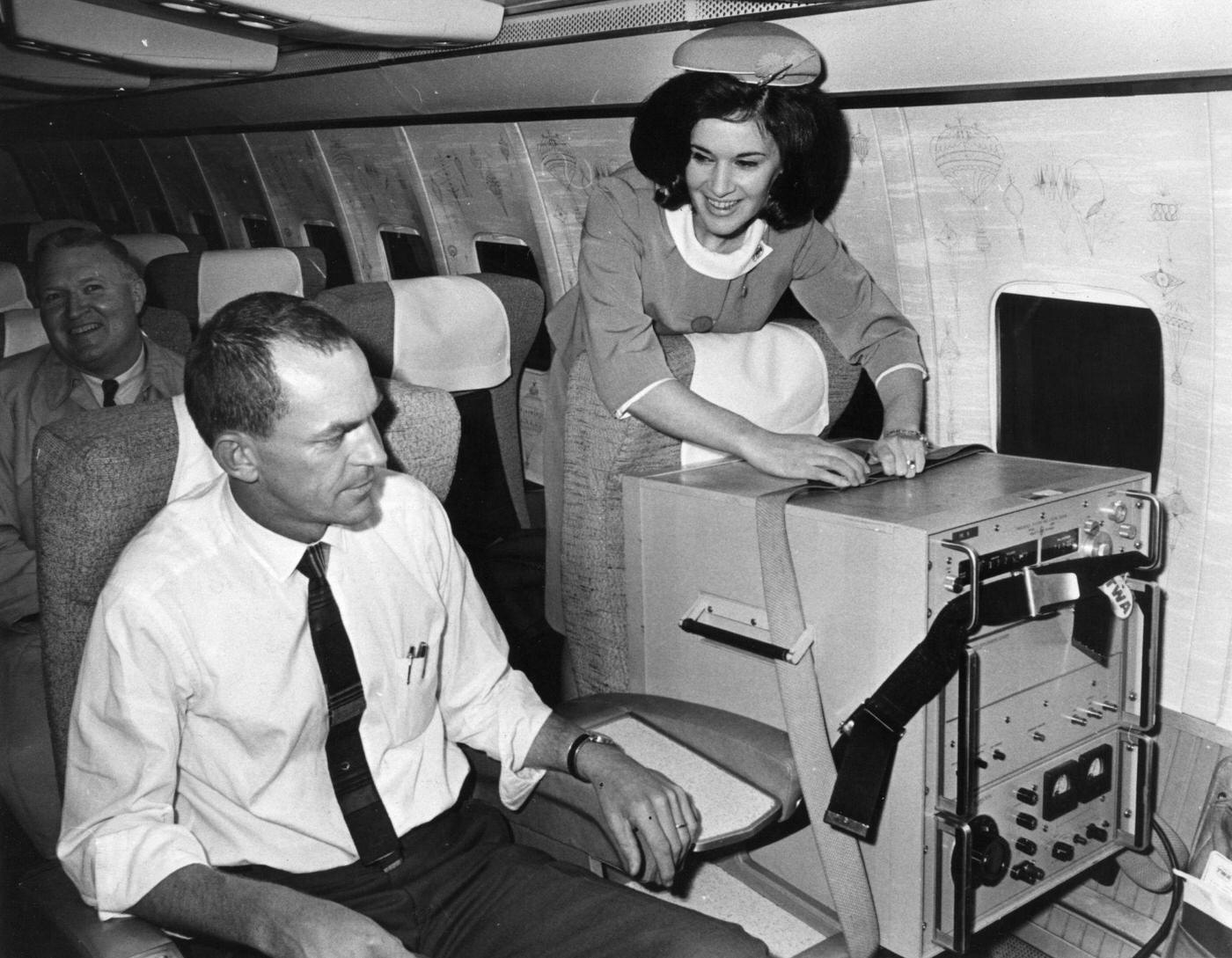 Two first-class seats aboard a TWA jet from London to Washington, one occupied by a caesium beam timepiece accurate to one-millioneth of a second used in the USA's space programme. Date unspecified.